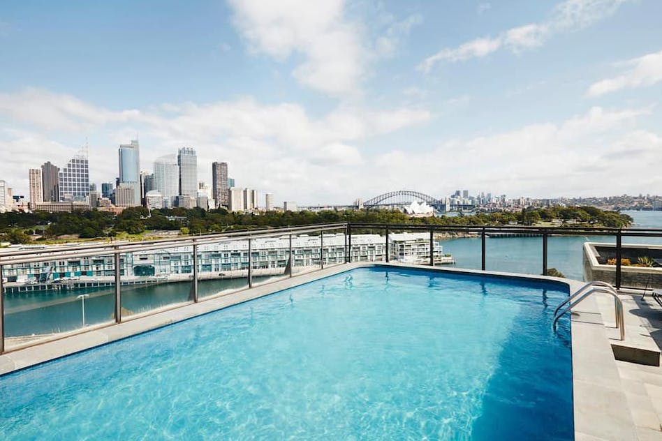 A rooftop pool with a view of Sydney Harbour